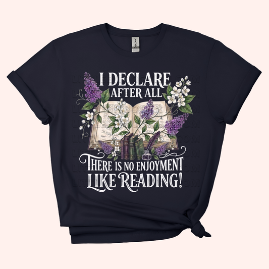 Black unisex t-shirt with a floral and stacked books design, featuring the text "I declare after all there is no enjoyment like reading" in large white letters — Pride & Prejudice quote t-shirt by Little Bit Bookish.