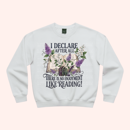 White unisex sweatshirt with a floral and stacked books design, featuring the text "I declare after all there is no enjoyment like reading" in large black letters — Pride & Prejudice quote sweatshirt by Little Bit Bookish.