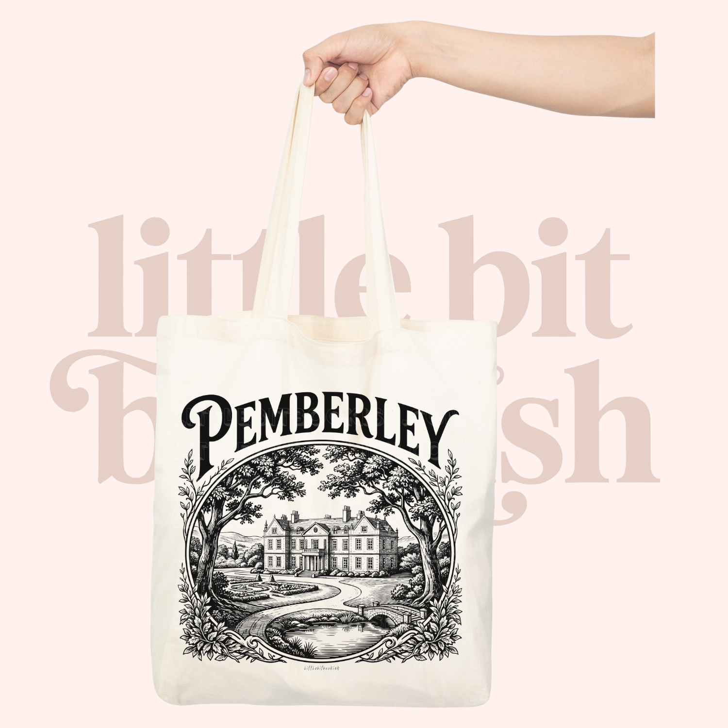 natural tote bag with 'Pemberley' design held by a hand on a light pink background.