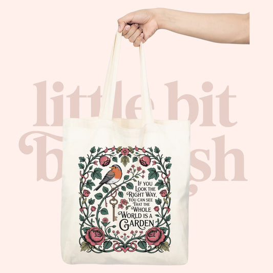 The Whole World is a Garden white canvas tote bag with botanical quote illustration featuring florals and a Red Robin, inspired by The Secret Garden by Frances Hodgson Burnett