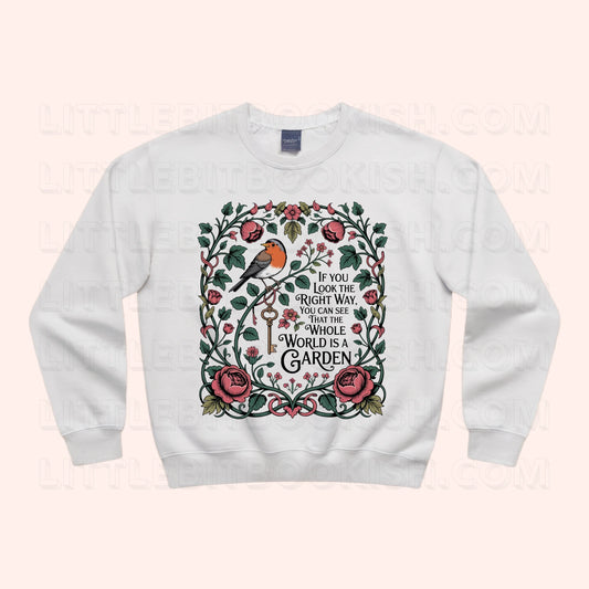 The Whole World is a Garden unisex sweatshirt with botanical quote illustration featuring florals and a Red Robin, inspired by The Secret Garden by Frances Hodgson Burnett