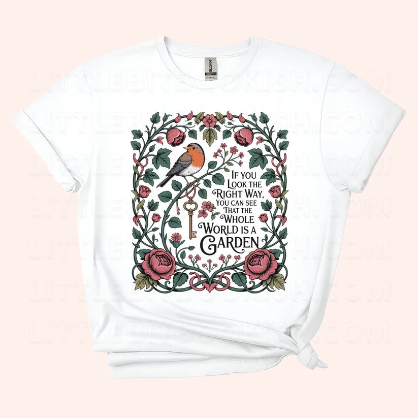 The Whole World is a Garden unisex t-shirt with botanical quote illustration featuring florals and a Red Robin, inspired by The Secret Garden by Frances Hodgson Burnett