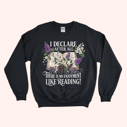 Black unisex sweatshirt with a floral and stacked books design, featuring the text "I declare after all there is no enjoyment like reading" in large white letters — Pride & Prejudice quote sweatshirt by Little Bit Bookish.