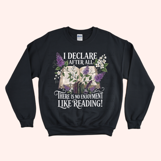Black unisex sweatshirt with a floral and stacked books design, featuring the text "I declare after all there is no enjoyment like reading" in large white letters — Pride & Prejudice quote sweatshirt by Little Bit Bookish.