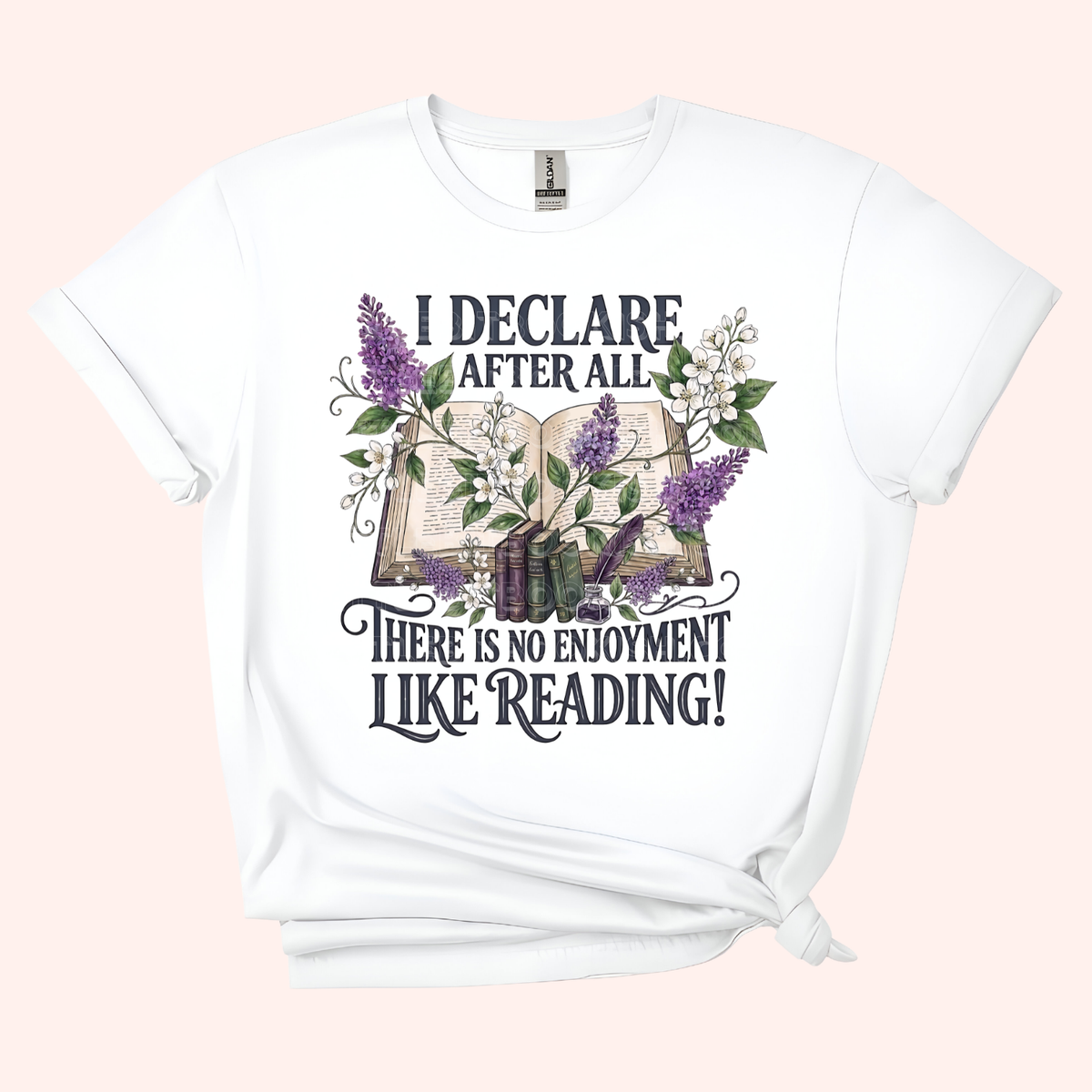 White unisex t-shirt with a floral and stacked books design, featuring the text "I declare after all there is no enjoyment like reading" in large black letters — Pride & Prejudice quote t-shirt by Little Bit Bookish.