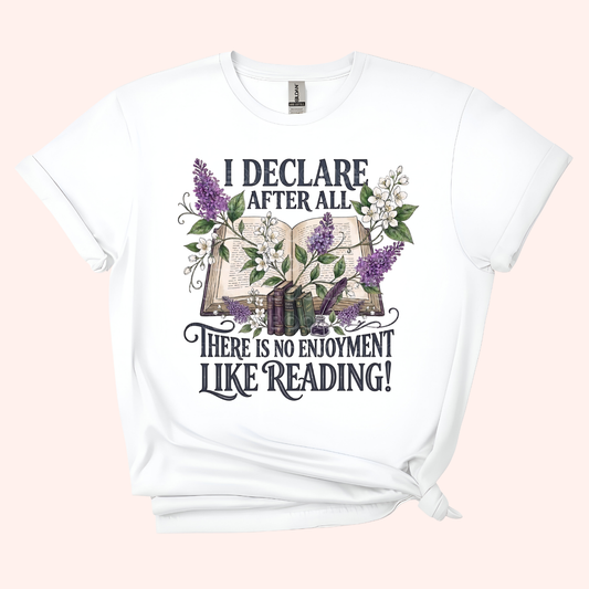 White unisex t-shirt with a floral and stacked books design, featuring the text "I declare after all there is no enjoyment like reading" in large black letters — Pride & Prejudice quote t-shirt by Little Bit Bookish.